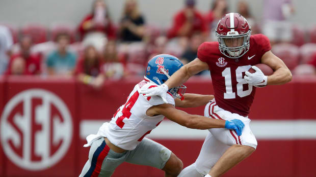 Alabama wide receiver Slade Bolden (18) attempts to break a tackle by Ole Miss defensive back Deane Leonard (24) at Bryant-Denny Stadium. Alabama defeated Ole Miss 42-21.