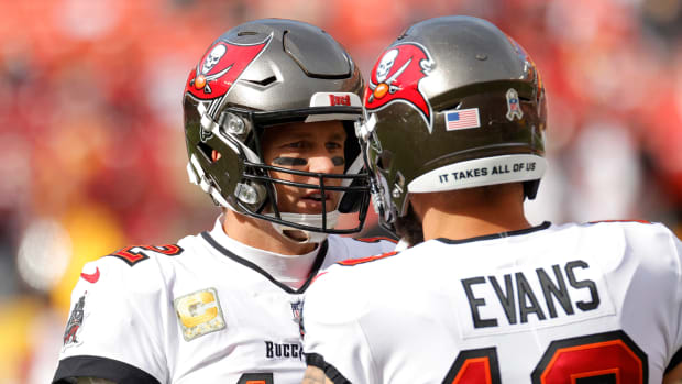 Nov 14, 2021; Landover, Maryland, USA; Tampa Bay Buccaneers quarterback Tom Brady (12) talks with Buccaneers wide receiver Mike Evans (13) during warmups prior to the game against the Washington Football Team at FedExField. Mandatory Credit: Geoff Burke-USA TODAY Sports