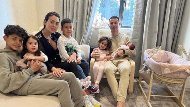 Cristiano Ronaldo pictured holding his new baby daughter as he sits alongside Georgina Rodriguez and their family