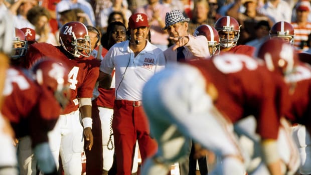 Alabama Crimson Tide head coach Paul Bear Bryant (right) with assistant coach Mal Moore (left) on the sideline against the Auburn Tigers at Legion Field.
