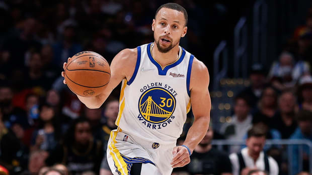 Golden State Warriors guard Stephen Curry (30) dribbles the ball up court \in the third quarter against the Denver Nuggets during game three of the first round for the 2022 NBA playoffs.