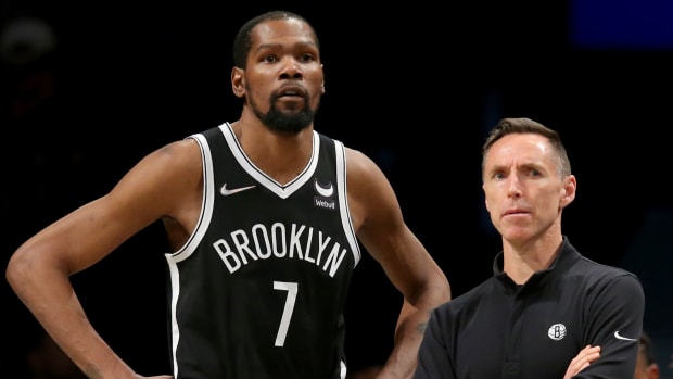 Brooklyn Nets head coach Steve Nash and forward Kevin Durant (7) watch during the fourth quarter against the Detroit Pistons at Barclays Center. The Nets defeated the Pistons 130-123.