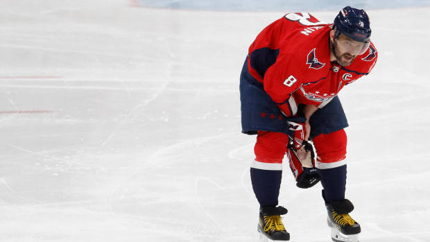 Capitals left wing Alex Ovechkin (8) skates off the ice after being injured while crashing into the boards after being tripped on a breakaway attempt.