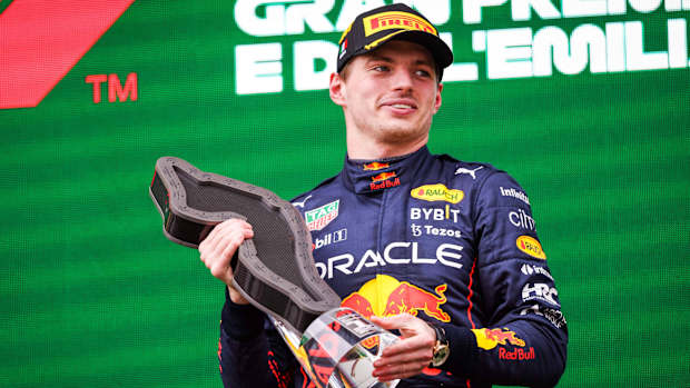 Max Verstappen holds the first-place trophy after winning the 2022 Emilia Romagna Grand Prix.