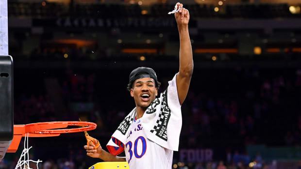 Kansas guard Ochai Agbaji (30) reacts after cutting down the net after their win against North Carolina in the 2022 NCAA men’s basketball tournament Final Four.