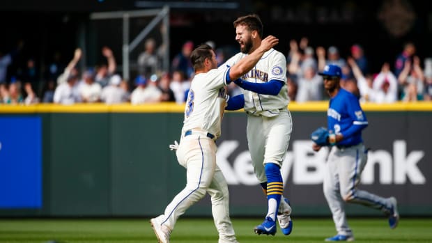 Apr 24, 2022; Seattle, Washington, USA; Seattle Mariners right fielder Jesse Winker (27, right) celebrates with third baseman Ty France (23) after hitting a walk-off RBI-single against the Kansas City Royals during the twelfth inning at T-Mobile Park. Seattle defeated Kansas City, 5-4. Mandatory Credit: Joe Nicholson-USA TODAY Sports