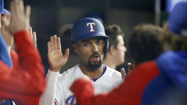 Apr 25, 2022; Arlington, Texas, USA; Texas Rangers second baseman Marcus Semien (2) is congratulated after scoring a run in the seventh inning against the Houston Astros at Globe Life Field. Mandatory Credit: Tim Heitman-USA TODAY Sports