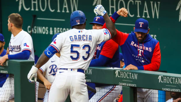 Apr 26, 2022; Arlington, Texas, USA; Texas Rangers center fielder Adolis Garcia (53) celebrates with manager Chris Woodward (8) after hitting a home run during the second inning against the Houston Astros at Globe Life Field. Mandatory Credit: Kevin Jairaj-USA TODAY Sports