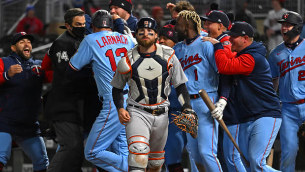 Detroit Tigers catcher Eric Haase (13) walks off the field as the Minnesota Twins celebrate their walk-off win as a result of his throwing error during the ninth inning at Target Field.