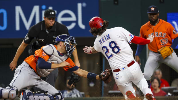 Apr 27, 2022; Arlington, Texas, USA; Houston Astros catcher Jason Castro (18) tags out Texas Rangers catcher Jonah Heim (28) at home plate during the second inning at Globe Life Field. Mandatory Credit: Kevin Jairaj-USA TODAY Sports