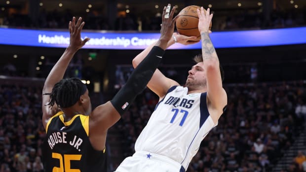 Dallas Mavericks guard Luka Doncic (77) steps back to shoot the ball over Utah Jazz Danuel House Jr. (25) in the second quarter during game six of the first round for the 2022 NBA playoffs at Vivint Arena.