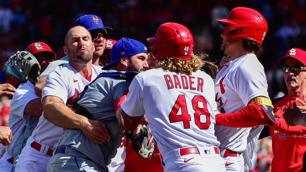 Benches clear as St. Louis Cardinals designated hitter Nolan Arenado (28) reacts with New York Mets catcher Tomas Nido (3) and relief pitcher Yoan Lopez (44) after a high and tight pitch during the eighth inning at Busch Stadium.