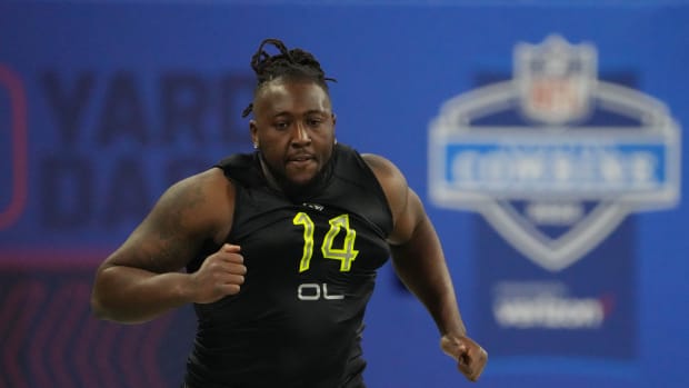 Mar 4, 2022; Indianapolis, IN, USA; North Carolina offensive lineman Joshua Ezeudu (OL14) runs the 40-yard dash during the 2022 NFL Scouting Combine at Lucas Oil Stadium.