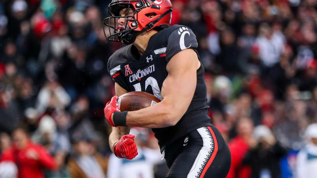 Nov 20, 2021; Cincinnati, Ohio, USA; Cincinnati Bearcats wide receiver Alec Pierce (12) reacts after scoring a touchdown against the Southern Methodist Mustangs in the first half at Nippert Stadium.