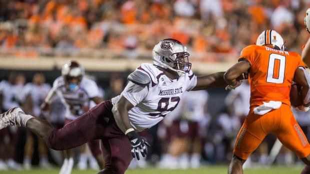 Sep 4, 2021; Stillwater, Oklahoma, USA; Missouri State Bears defensive lineman Eric Johnson (93) reaches out to try and stop Oklahoma State Cowboys running back LD Brown (0) during the third quarter at Boone Pickens Stadium. Oklahoma State Cowboys beat Missouri State Bears 23-16.