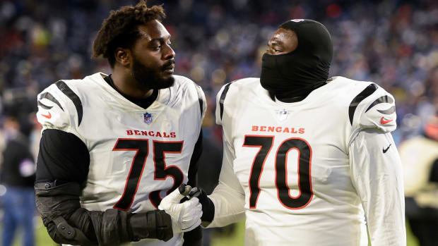 Jan 22, 2022; Nashville, Tennessee, USA; Cincinnati Bengals offensive tackle Isaiah Prince (75) and Cincinnati Bengals offensive tackle D'Ante Smith (70) celebrate the win as they walk of the field against the Tennessee Titans during the second half during a AFC Divisional playoff football game at Nissan Stadium. Mandatory Credit: Steve Roberts-USA TODAY Sports