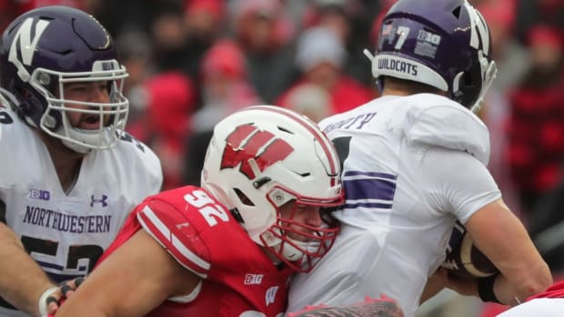 Wisconsin defensive end Matt Henningsen (92) sacks Northwestern quarterback Andrew Marty (7) during the second quarter of their game on Saturday, November 13, 2021 at Camp Randall Stadium in Madison, Wis. Wisconsin beat Northwestern 35-7.