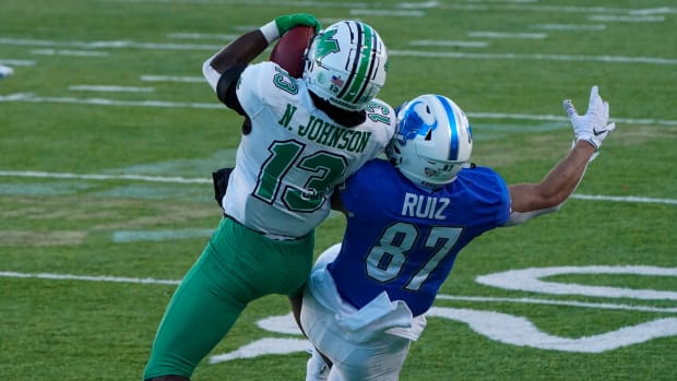 Dec 25, 2020; Montgomery, AL, USA; Marshall Thundering Herd safety Nazeeh Johnson (13) intercepts a pass intended for Buffalo Bulls wide receiver Jovany Ruiz (87) during the second half at Cramton Bowl Stadium. Mandatory Credit: Marvin Gentry-USA TODAY Sports