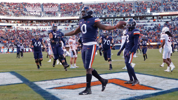 Nov 27, 2021; Charlottesville, Virginia, USA; Virginia Cavaliers tight end Jelani Woods (0) celebrates after scoring a touchdown against the Virginia Tech Hokies during the first quarter at Scott Stadium. Mandatory Credit: Geoff Burke-USA TODAY Sports