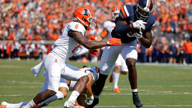 Sep 11, 2021; Charlottesville, Virginia, USA; Virginia Cavaliers tight end Jelani Woods (0) catches a touchdown pass as Illinois Fighting Illini defensive back Tony Adams (6) defends in the first quarter at Scott Stadium. Mandatory Credit: Geoff Burke-USA TODAY Sports