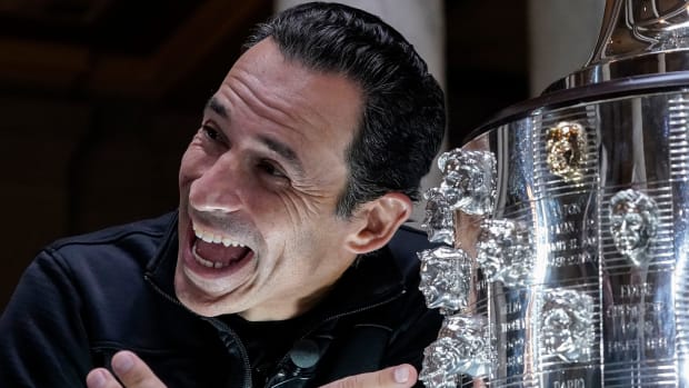 Helio Castroneves admires his face on the Borg-Warner Trophy for winning the Indianapolis 500 a record-tying four times. Photo: Grace Hollars/IndyStar-USA TODAY Network