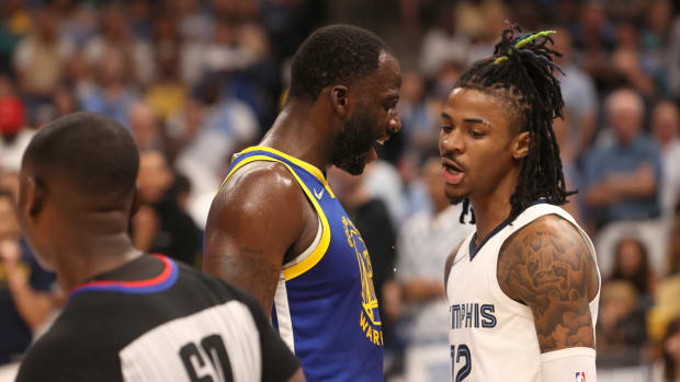 May 1, 2022; Memphis, Tennessee, USA; Golden State Warriors forward Draymond Green (23) and Memphis Grizzlies guard Ja Morant (12) have words during game one of the second round for the 2022 NBA playoffs at FedExForum.