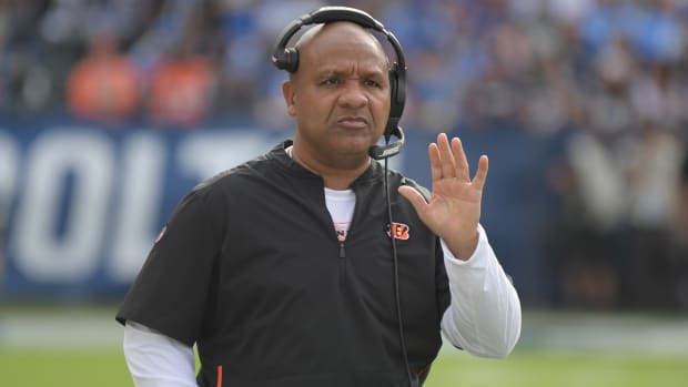 Former Browns head coach Hue Jackson watches from the sidelines during a game.