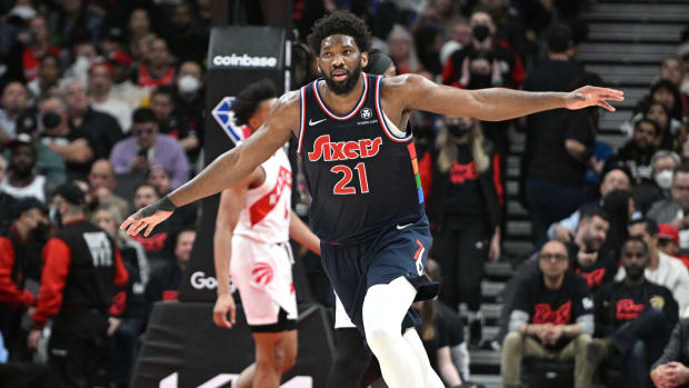 76ers center Joel Embiid (21) reacts after scoring a basket against the Raptors.