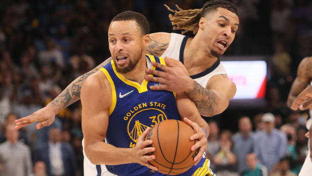 Memphis Grizzlies forward Brandon Clark (15) defends Golden State Warriors guard Stephen Curry.