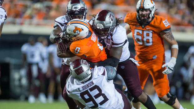Sep 4, 2021; Stillwater, Oklahoma, USA; Missouri State Bears defensive lineman Eric Johnson (93) and defensive end Kevin Ellis (right) and defensive end Jalen Williams (95) tackle Oklahoma State Cowboys running back LD Brown (0) during the third quarter at Boone Pickens Stadium. Oklahoma State Cowboys beat Missouri State Bears 23-16. Mandatory Credit: Brett Rojo-USA TODAY Sports