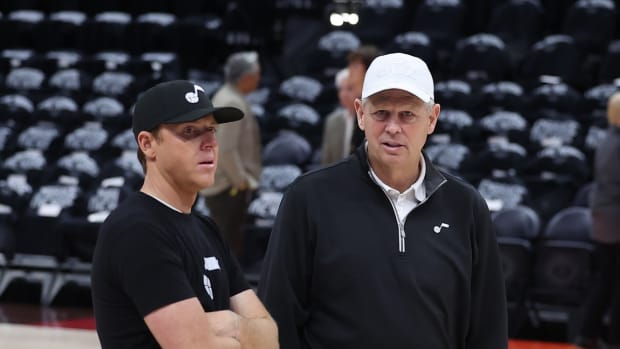 Utah Jazz owner Ryan Smith speaks with Utah Jazz CEO of basketball operations Danny Ainge prior to a game against the Dallas Mavericks during game six of the first round for the 2022 NBA playoffs at Vivint Arena.