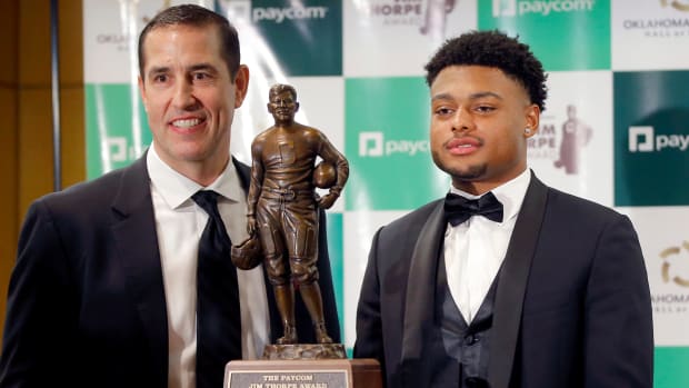 Jim Thorpe Award winner Coby Bryant, from Cincinnati, poses for a photo beside his coach Luke Fickell at the National Cowboy & Western Heritage Museum in Oklahoma City, Tuesday, Feb. 8, 2022. web only