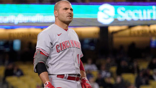 Cincinnati Reds’ Joey Votto reacts as a long ball that he hit just barely went foul during the ninth inning of a baseball game against the Los Angeles Dodgers Saturday, April 16, 2022, in Los Angeles.