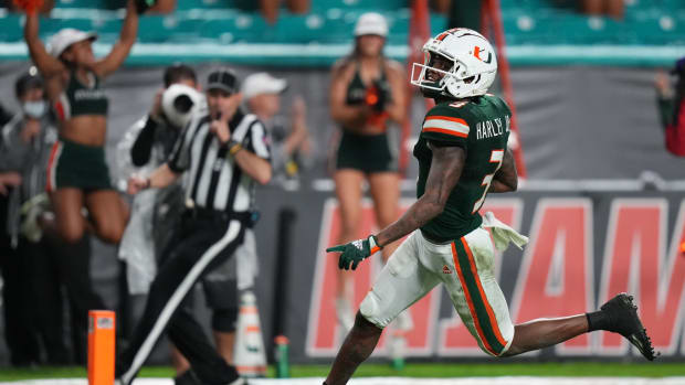 Nov 20, 2021; Miami Gardens, Florida, USA; Miami Hurricanes wide receiver Mike Harley (3) runs for a touchdown after a catch against the Virginia Tech Hokies during the second half at Hard Rock Stadium. Mandatory Credit: Jasen Vinlove-USA TODAY Sports