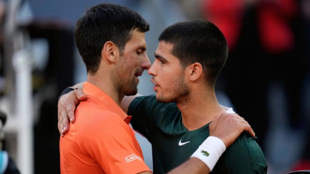Novak Djokovic, left, shakes hands with Carlos Alcaraz at the end of a men's semifinal at the Mutua Madrid Open tennis tournament.