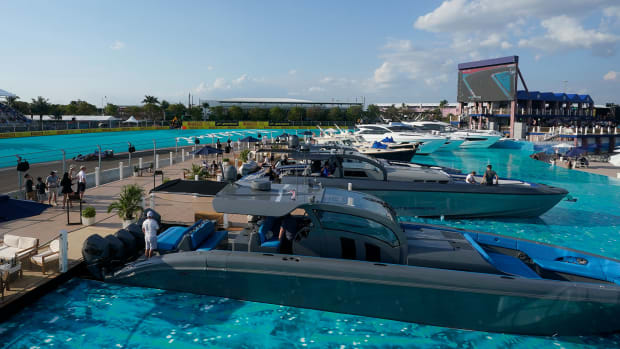 Spectators watch from boats installed in simulated water during the second practice session for the Formula One Miami Grand Prix auto race at the Miami International Autodrome, Friday, May 6, 2022, in Miami Gardens, Fla.
