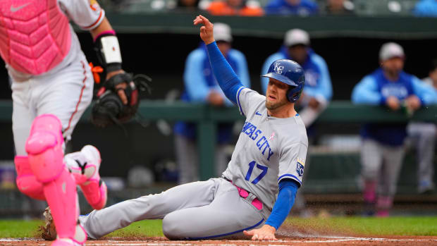 May 8, 2022; Baltimore, Maryland, USA; Kansas City Royals first baseman Hunter Dozier (17) slides safely into home on a sacrifice fly ball by Kansas City Royals second baseman Whit Merrifield (15) (not pictured) against the Baltimore Orioles during the second inning at Oriole Park at Camden Yards. Mandatory Credit: Gregory Fisher-USA TODAY Sports