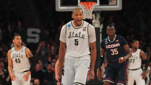 Mar 30, 2014; New York, NY, USA; Michigan State Spartans forward Adreian Payne (5) reacts after a three pointer against the Connecticut Huskies during the second half in the finals of the east regional of the 2014 NCAA Mens Basketball Championship tournament at Madison Square Garden.