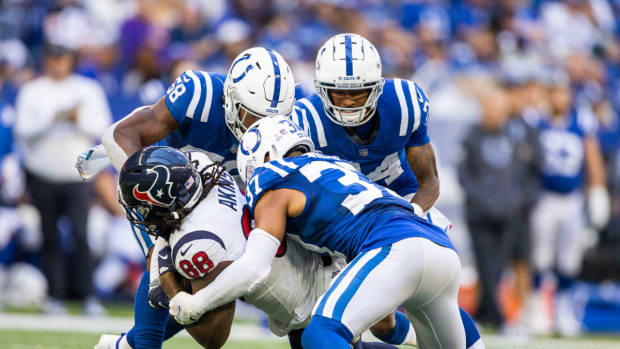 Oct 17, 2021; Indianapolis, Indiana, USA; Houston Texans tight end Jordan Akins (88) is tackled by Indianapolis Colts middle linebacker Bobby Okereke (58) and safety Khari Willis (37) in the second half at Lucas Oil Stadium.