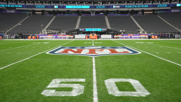 A closeup of the NFL logo on the field.