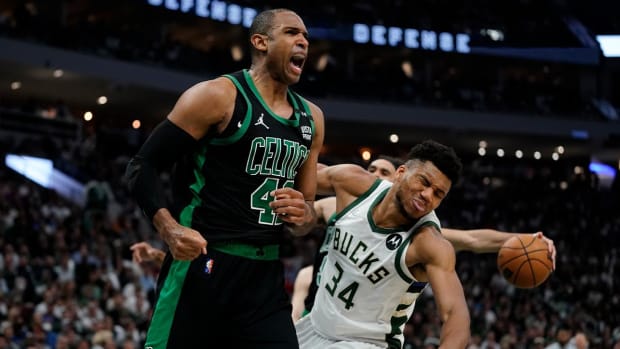 Boston Celtics’ Al Horford reacts in front of Milwaukee Bucks’ Giannis Antetokounmpo during the second half of Game 4 of an NBA basketball Eastern Conference semifinals playoff series Monday, May 9, 2022, in Milwaukee. The Celtics won 116-108 to tie the series 2-2.
