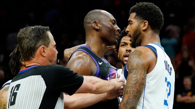 Referee David Guthrie (16) tries to separate Suns center Bismack Biyombo and Mavericks forward Marquese Chriss during Game 5 of the Western Conference semifinals.