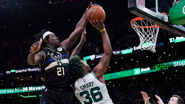 Bucks guard Jrue Holiday blocks Celtics guard Marcus Smart’s shot.