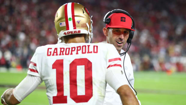 49ers quarterback Jimmy Garoppolo (10) stands with head coach Kyle Shanahan.