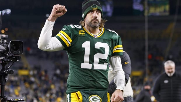 Aaron Rodgers celebrates a victory with a fist pump.