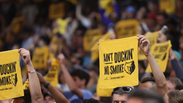 Memphis Grizzlies fans hold rally towels at a playoff game