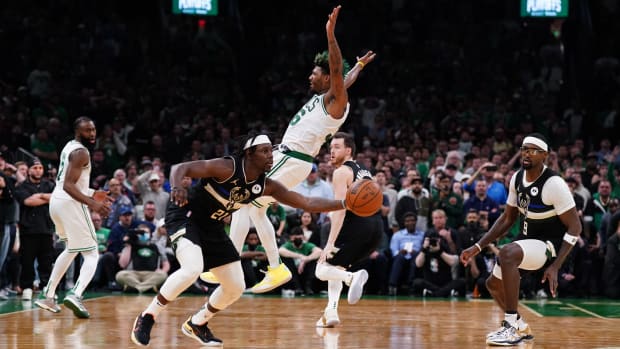 Milwaukee Bucks guard Jrue Holiday (21) steals the ball from Boston Celtics guard Marcus Smart (36) to end the game in the second half during game five of the second round for the 2022 NBA playoffs at TD Garden.