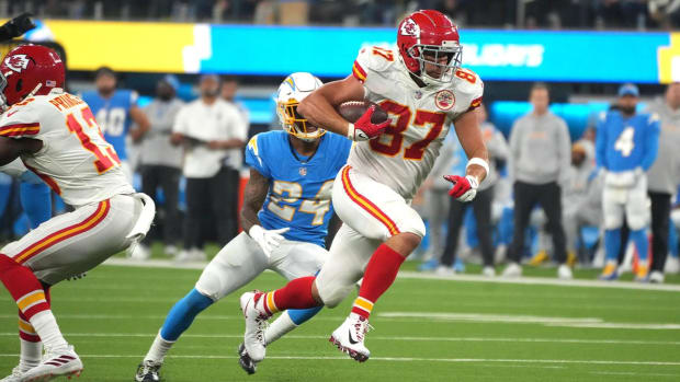 Dec 16, 2021; Inglewood, California, USA; Kansas City Chiefs tight end Travis Kelce (87) is pursued by Los Angeles Chargers safety Nasir Adderley (24) on a touchdown reception in overtime against the Los Angeles Chargers at SoFi Stadium.
