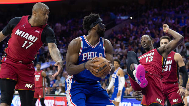 Philadelphia 76ers center Joel Embiid (center) controls the ball against Miami Heat forward P.J. Tucker (17) and center Bam Adebayo (13) during the third quarter in game six of the second round of the 2022 NBA playoffs.
