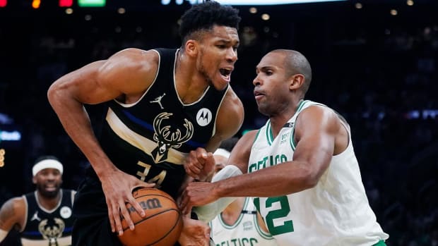 Boston Celtics center Al Horford (42) stops Milwaukee Bucks forward Giannis Antetokounmpo, left, on a drive to the basket during the first half of Game 5 of an Eastern Conference semifinal in the NBA basketball playoffs, Wednesday, May 11, 2022, in Boston.